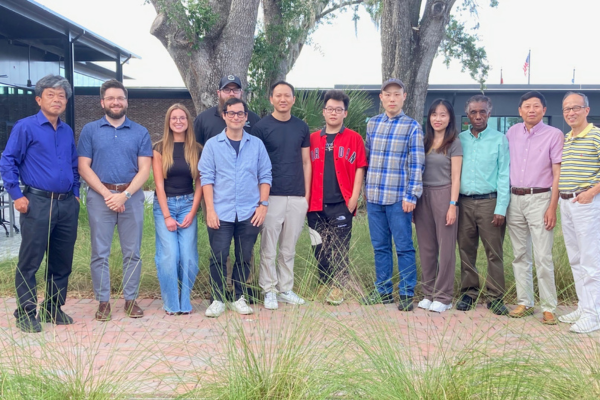 A group of Biostatistics PhD students posing with faculty from the Department of Biostatistics and Data Science