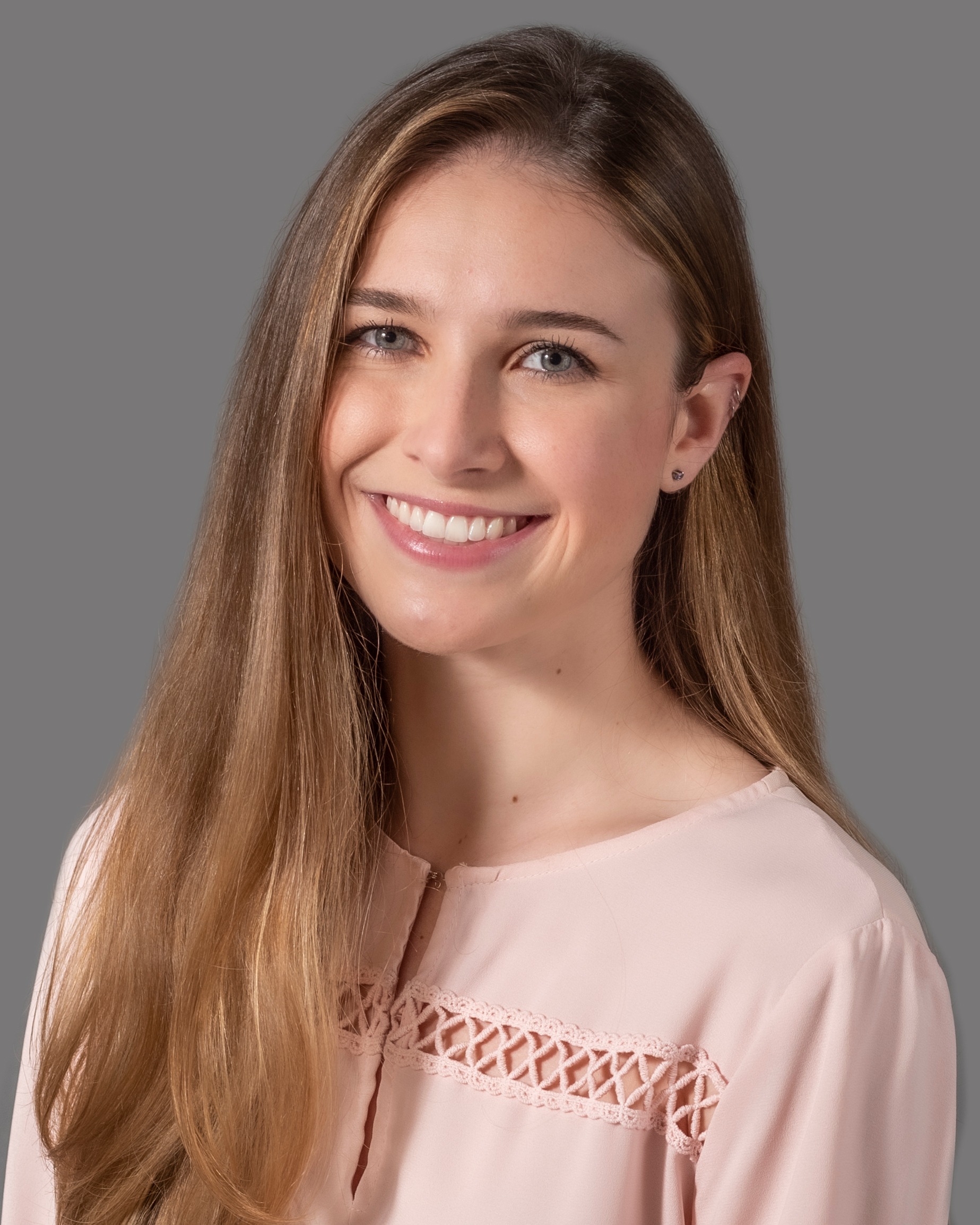 Kylie Unser smiling wearing a blush pink blouse