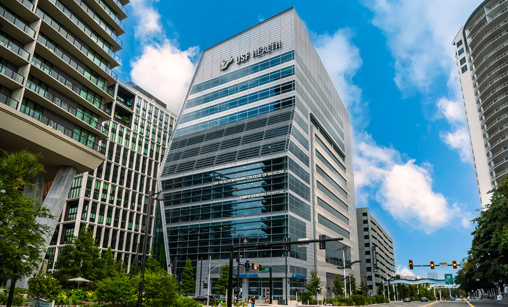 Street view of the USF Health Waterstreet skyscraper building with large glass windows
