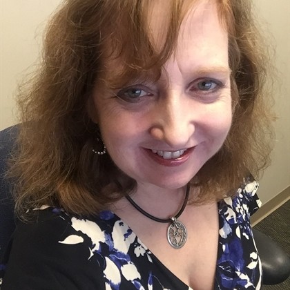Lisa Greene Smith smiling wearing a floral blouse