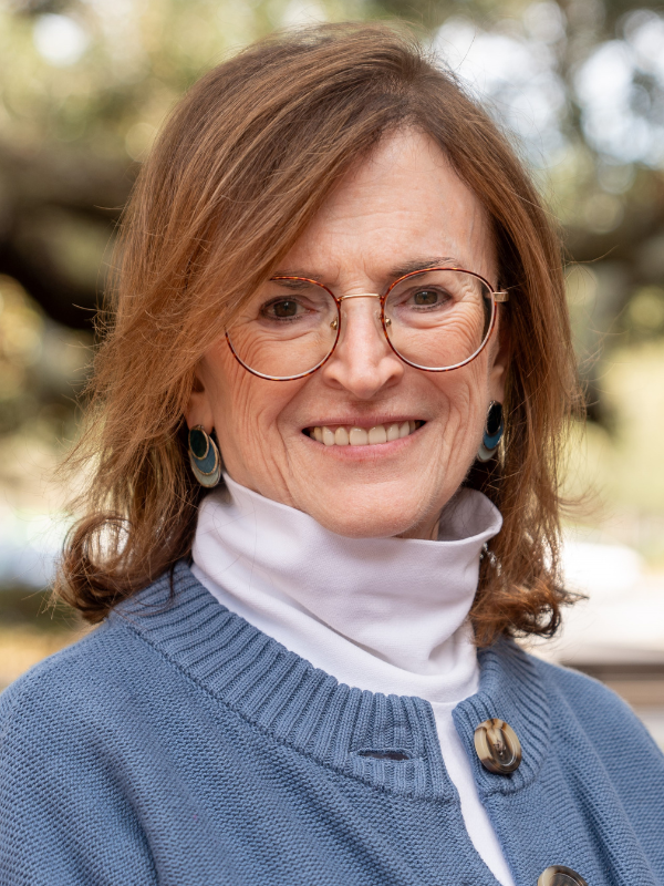 A headshot of Dr. Ellen Daley smiling in an outdoor setting