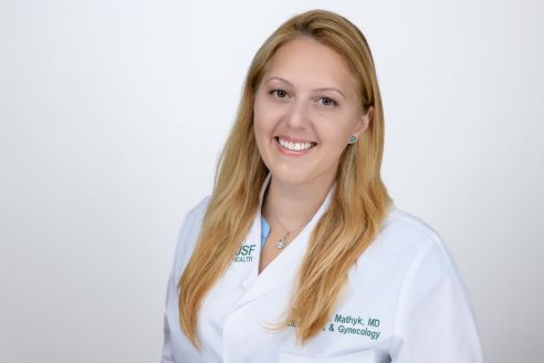 Dr. Begum Mathyk in a medical white coat