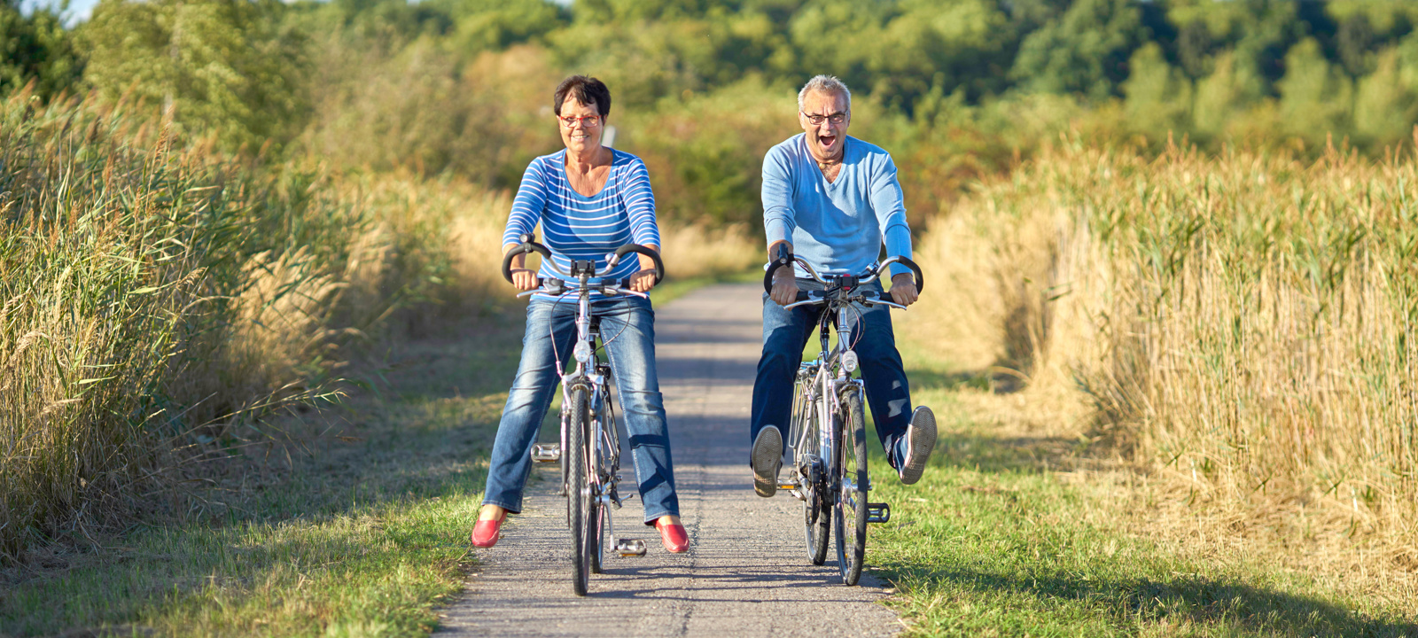 middle aged man and woman riding bikes 